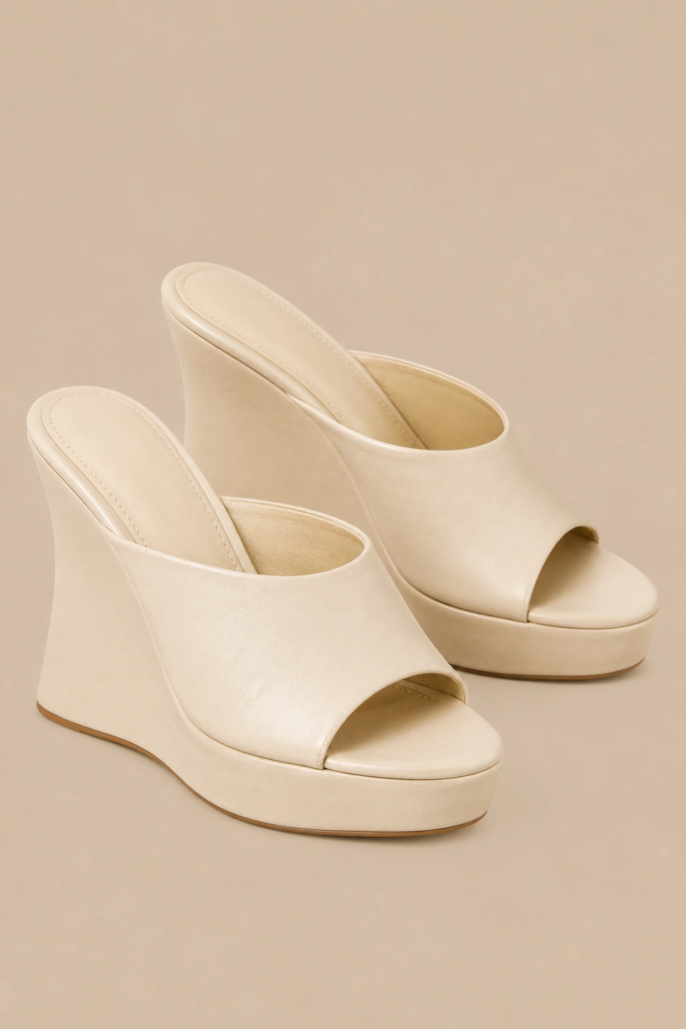 Minimal cream wedge platform mule heels with sleek sculpted wedge design, smooth neutral leather finish, elegant quiet luxury aesthetic, trendy Pinterest wedge mule heels for chic minimalist outfits.