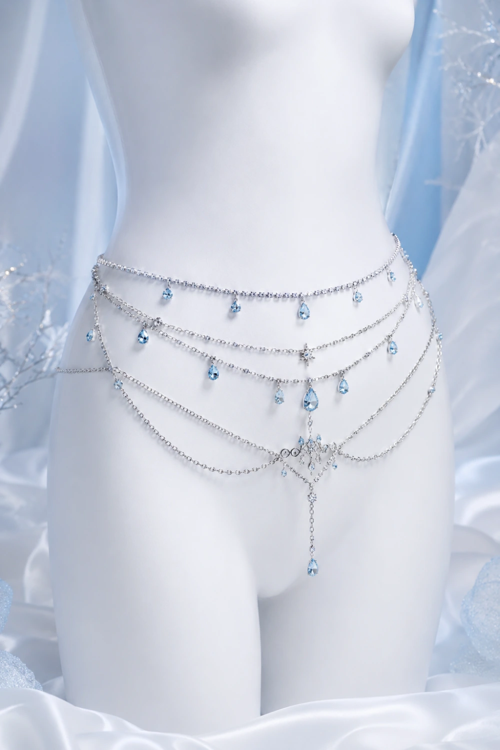 Luxury ice blue crystal waist chains with layered silver chains and dangling icy gemstones displayed in an elegant frozen glam fashion aesthetic for 2026 trends.