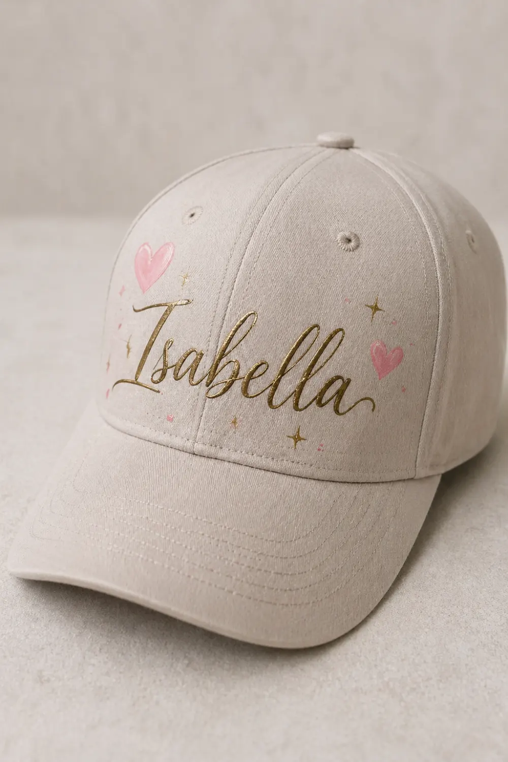 Beige hand painted cap with custom name lettering and small hearts, personalized DIY painted hat aesthetic
