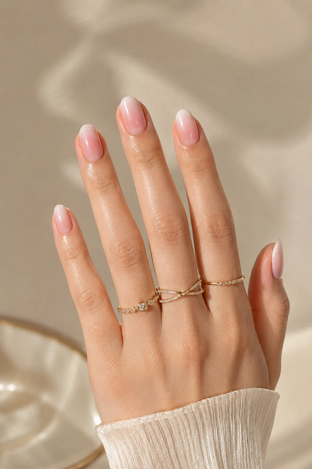 Strawberry milk ombre nails with sheer pink and milky white glossy gradient on short almond nails, featuring minimalist clean girl manicure styling and classy summer nail inspiration.