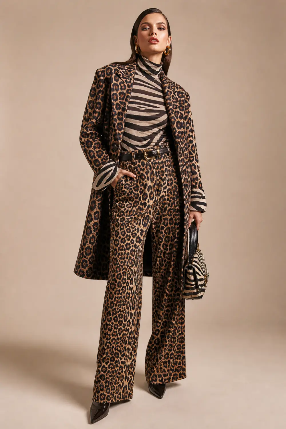 mixed animal print outfit with leopard suit and zebra top, high fashion female model studio editorial bold styling