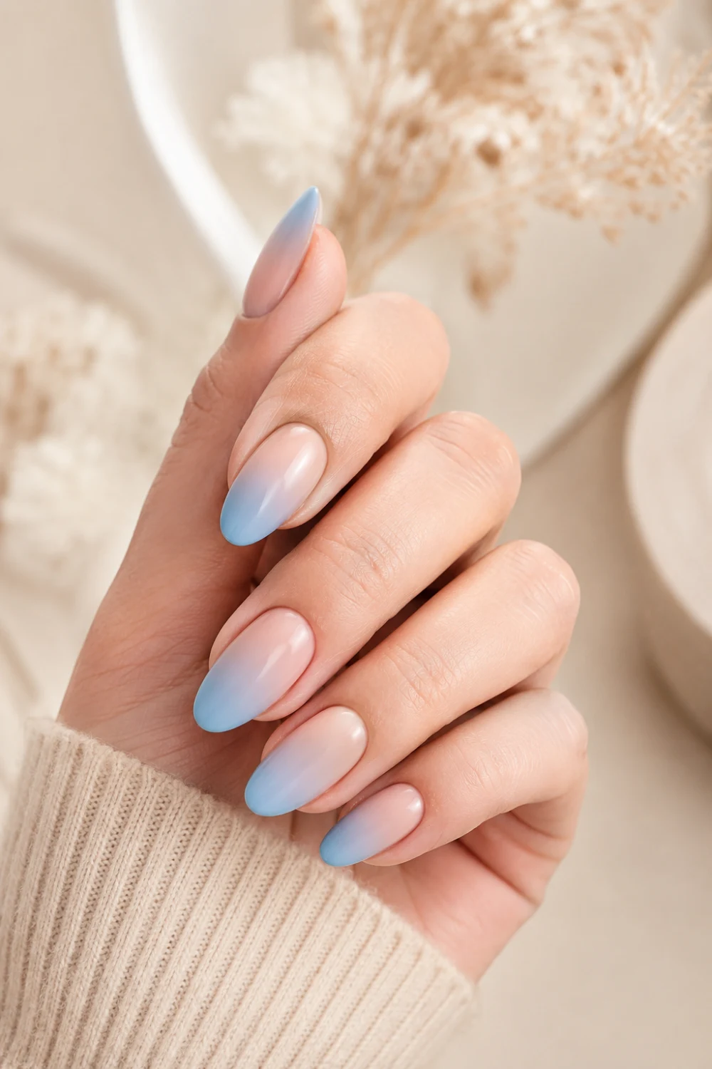 Blue ombre almond nails with glossy nude to pastel gradient, elegant feminine manicure design featuring trendy Pinterest-inspired soft glam aesthetic.
