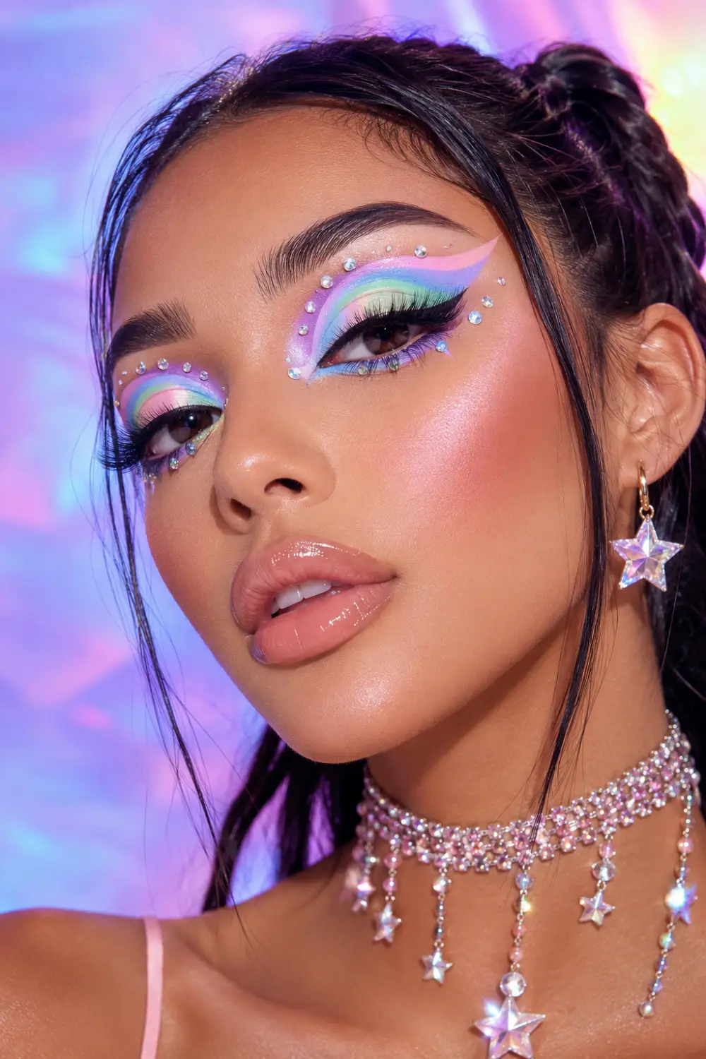 Pastel cut crease Y2K makeup with colorful pastel eyeshadow, rhinestone details, glossy nude lips, glowing skin, star jewelry, and dreamy retro glam beauty aesthetics.