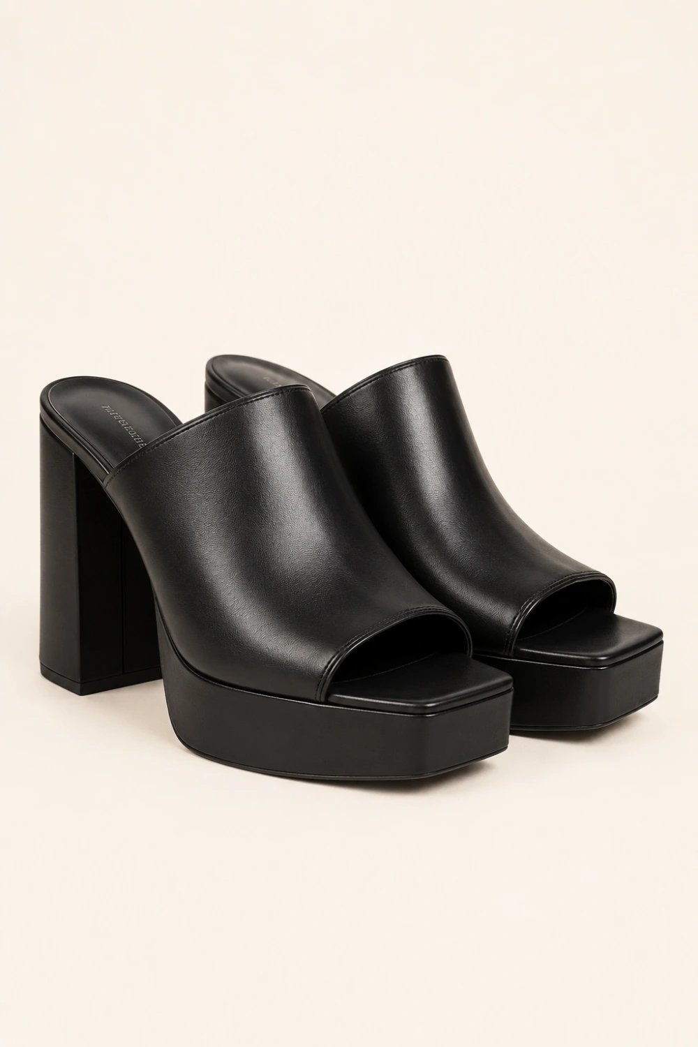 Elegant black leather platform mule heels with chunky block heel, sleek minimalist design, polished leather finish, luxury quiet fashion aesthetic, modern Pinterest-inspired mule heels for trendy dressy outfits in 2026.