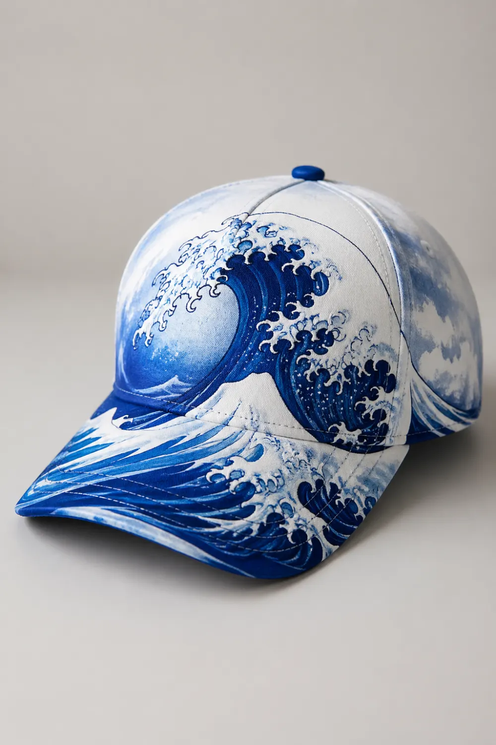 White and blue hand painted cap with ocean wave design, detailed Japanese wave style art, bold DIY painted cap aesthetic