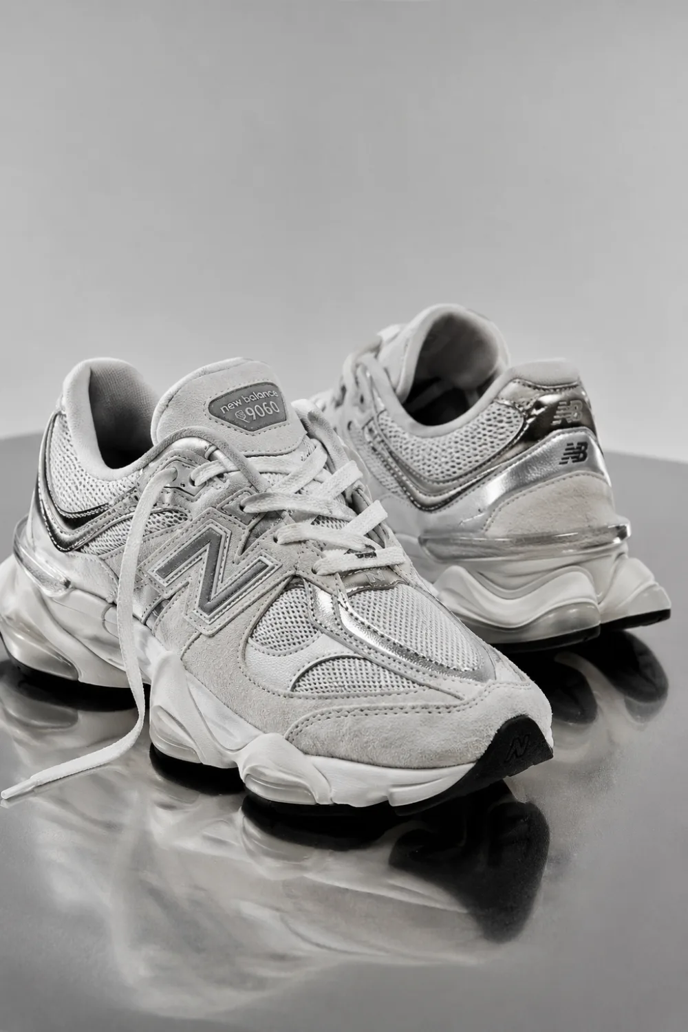 Chunky silver New Balance 9060 women sneakers with futuristic sporty aesthetic, metallic details, and oversized sole styled for clean girl outfits and trendy athleisure fashion inspiration.