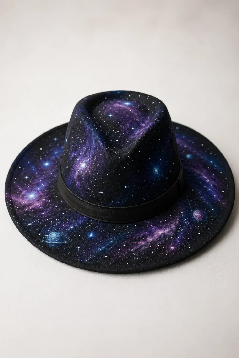 Black hand painted hat with galaxy night sky design, purple blue nebula and stars aesthetic DIY painted hat