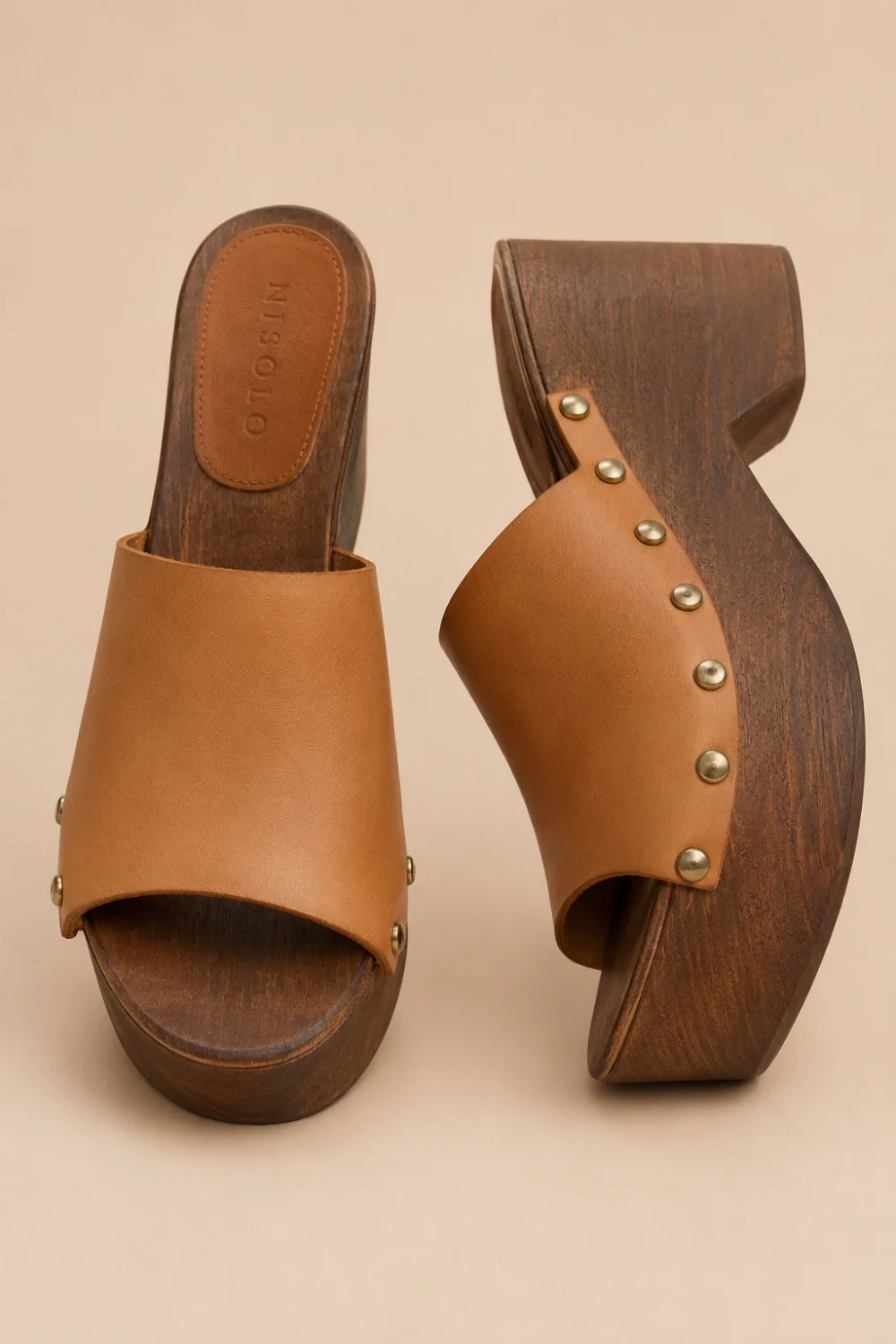 Vintage-inspired wooden platform mule sandals with rich brown wood sole, tan leather upper, metallic stud accents, retro boho aesthetic, trendy Pinterest platform sandals for chic summer fashion looks.