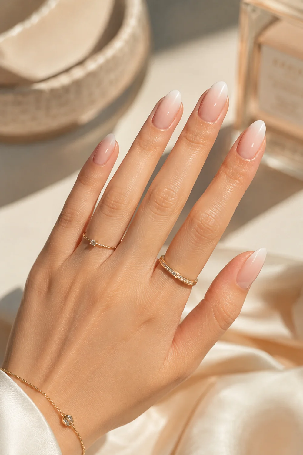 Milky nude ombre nails with sheer pink and creamy white gradient on glossy almond nails, featuring elegant clean girl manicure styling and luxury summer nail inspiration for 2026.