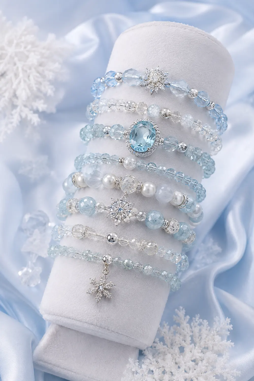 Elegant ice blue crystal beaded bracelets with pearls, silver accents, and snowflake charms displayed in a luxurious frozen glam jewelry aesthetic for 2026 trends.