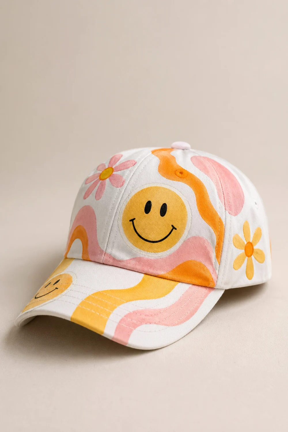 White hand painted cap with smiley face, pastel waves and flowers, retro aesthetic DIY painted hat design