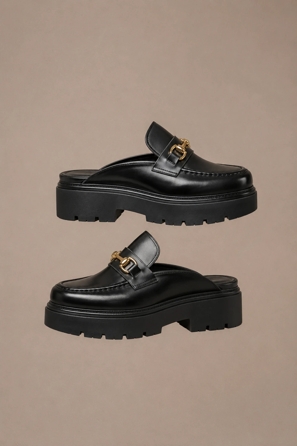 Black chunky loafer platform mules with polished leather finish, gold hardware detail, thick lug sole, luxury modern fashion aesthetic, trendy Pinterest loafers for chic street-style outfits in 2026.