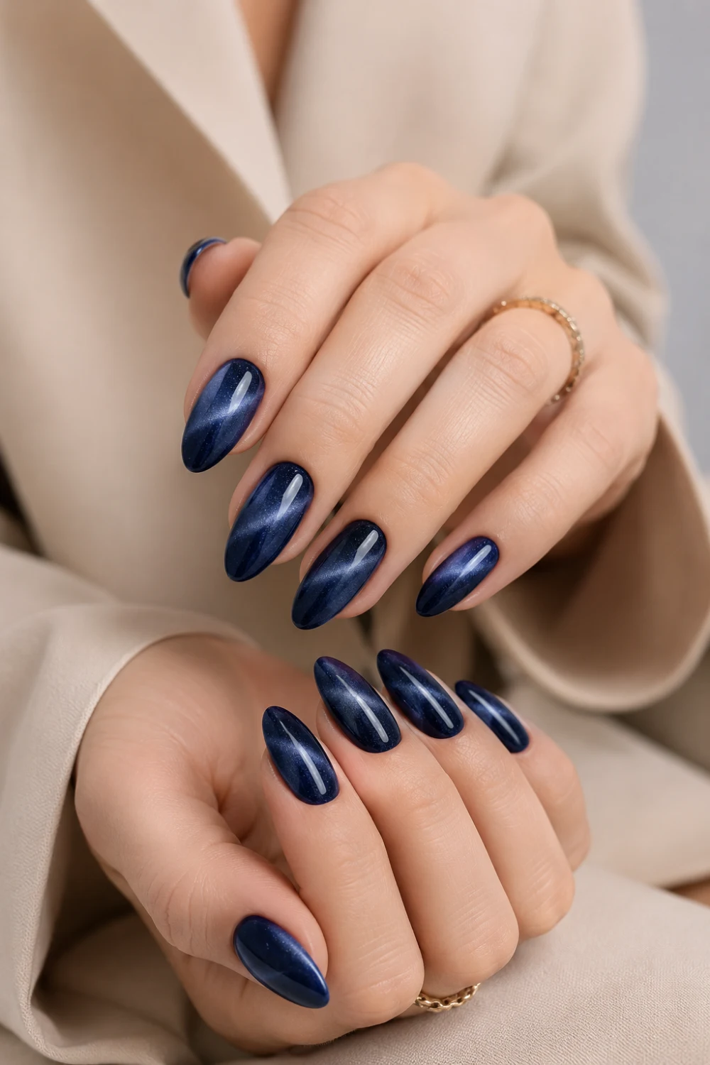Navy blue cat eye almond nails with magnetic velvet shimmer effect, glossy dark blue manicure design featuring luxurious Pinterest-inspired glam styling.