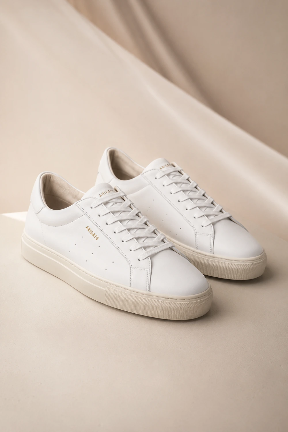 Minimal white leather women sneakers with clean luxury aesthetic and sleek low-top silhouette styled for classy everyday outfits and modern minimalist fashion inspiration.