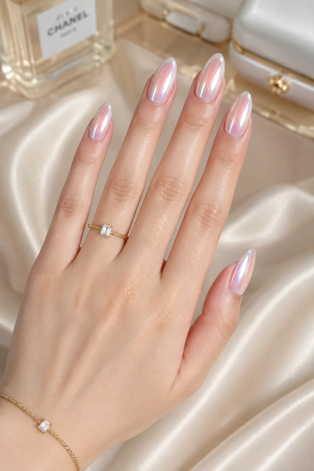 Chrome glazed ombre nails with pearly pink and reflective white gradient on glossy almond nails, featuring luxury chrome manicure styling and elegant summer nail inspiration for 2026.