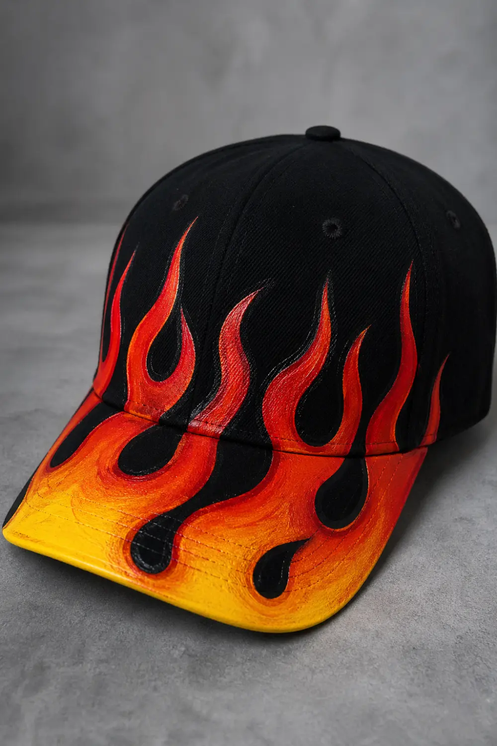 Black hand painted cap with red orange yellow flame design, bold street style DIY painted cap aesthetic