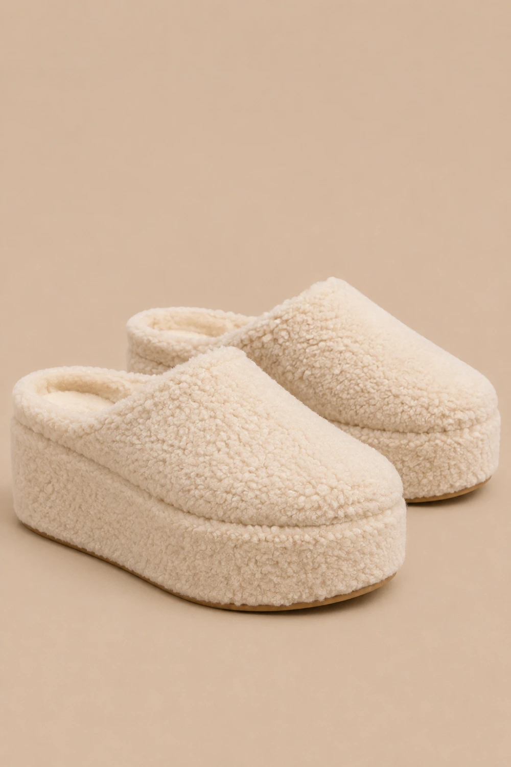 Cream sherpa platform mule slippers with fluffy cozy texture, chunky elevated sole, soft neutral cozy-core aesthetic, trendy Pinterest platform slippers for stylish lounge and winter outfits.
