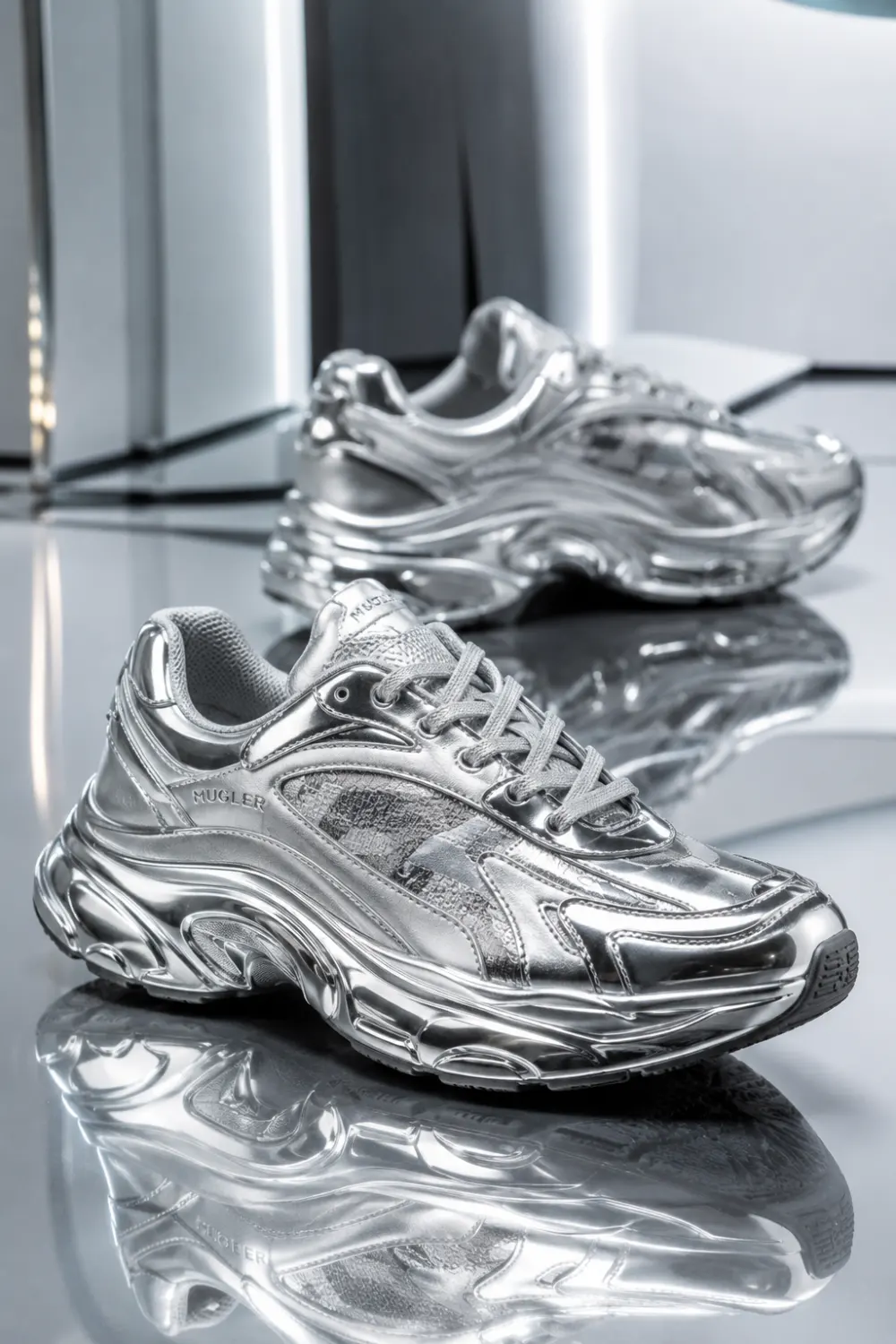 Futuristic metallic chrome women sneakers with reflective silver finish and chunky sporty silhouette styled for trendy streetwear outfits and Pinterest fashion inspiration in 2026.