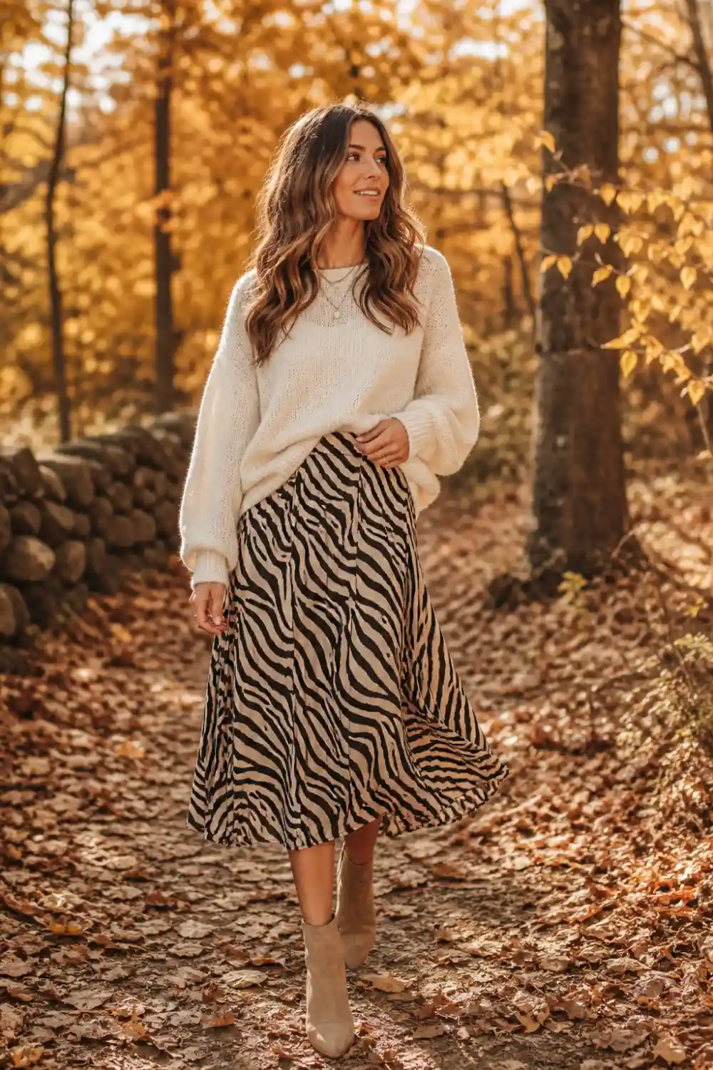 zebra print midi skirt with cozy knit sweater and ankle boots, autumn outdoor outfit female model warm aesthetic look