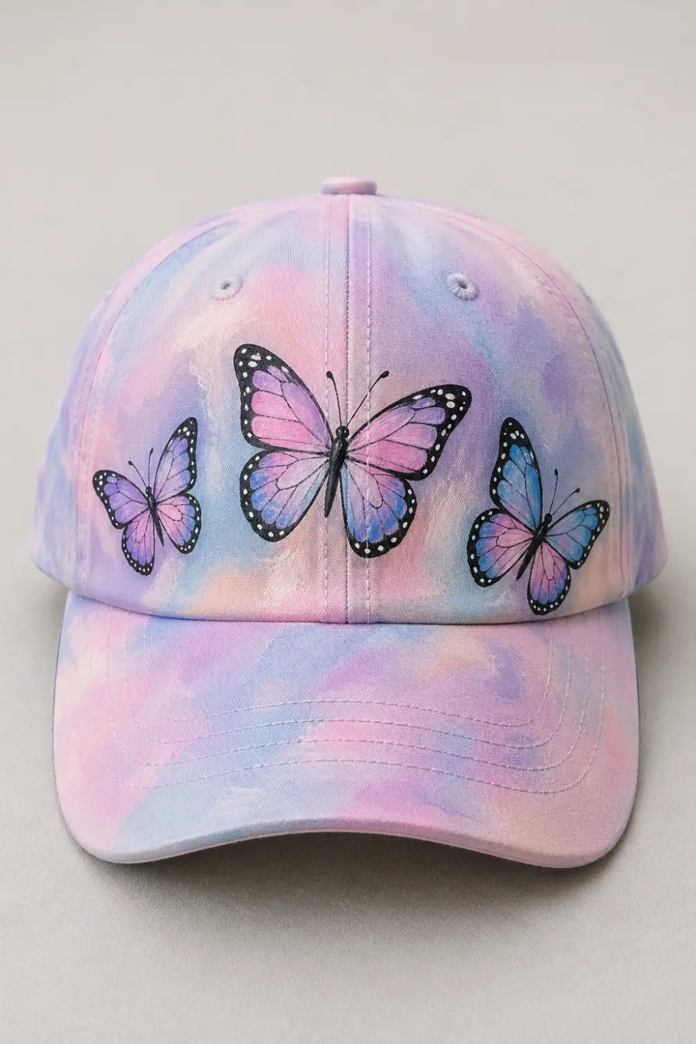 Pastel hand painted cap with butterfly design in pink purple and blue, soft dreamy aesthetic DIY painted hat