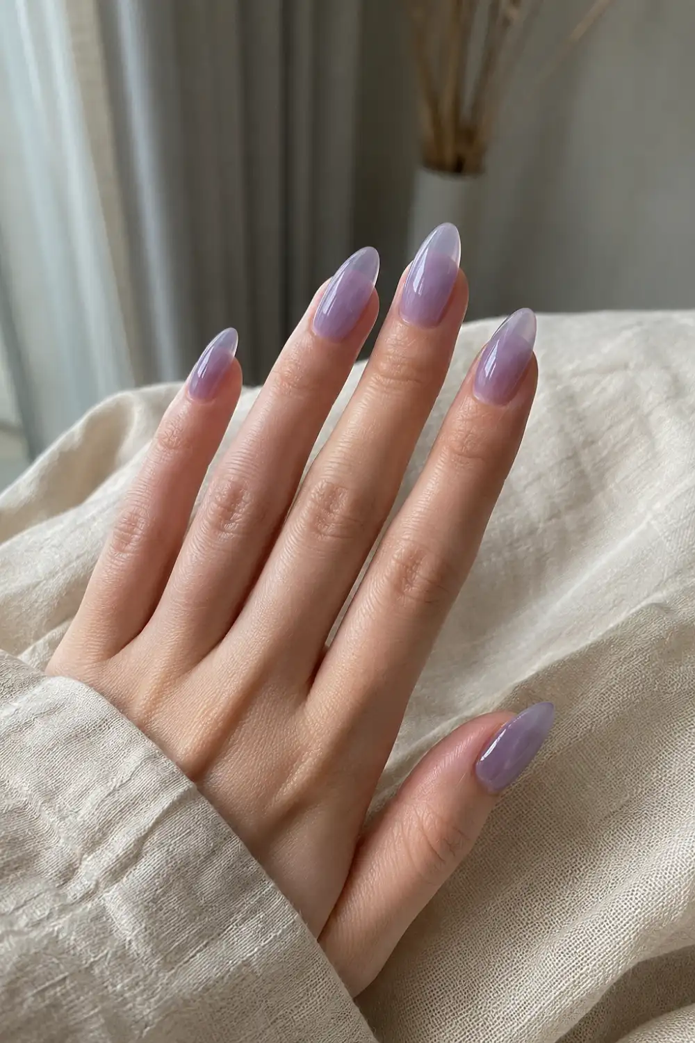 Lavender jelly almond nails with soft translucent purple gel polish, glossy finish, elegant almond shape, and a dreamy pastel manicure aesthetic.