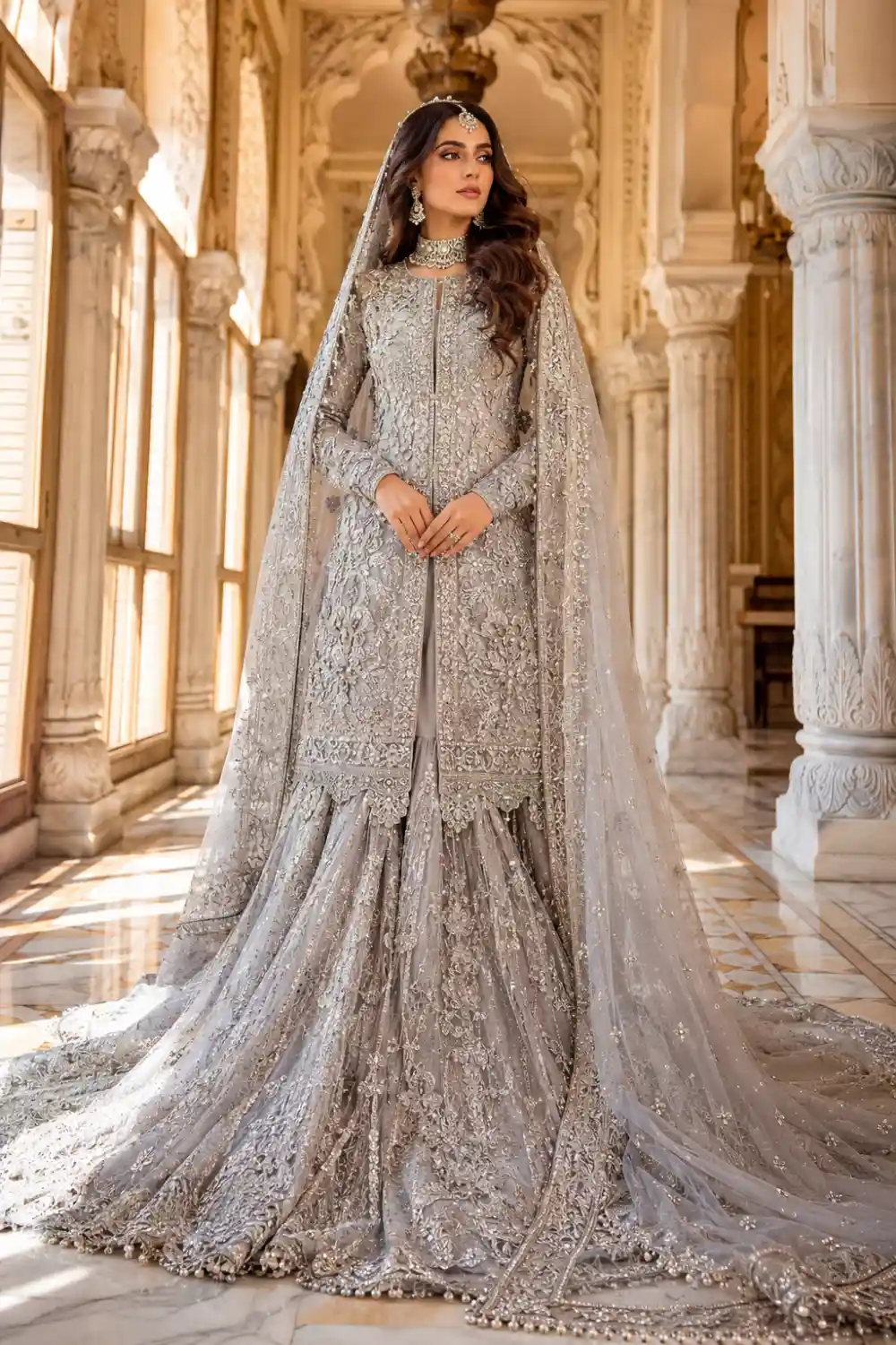 Moonlight silver grey Pakistani farshi sharara featuring a heavily embroidered long shirt, crystal embellishments, intricate threadwork, and a luxurious embellished dupatta. Traditional designer formal outfit perfect for wedding functions, receptions, festive celebrations, and Pakistani couture fashion.