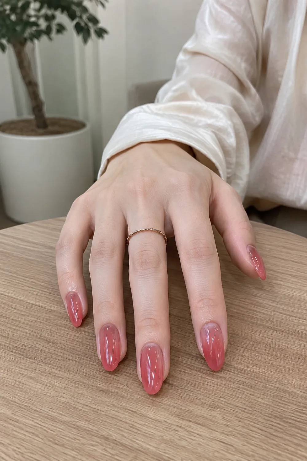 Strawberry syrup jelly almond nails with a translucent pink gradient, glossy gel finish, and soft glass-like shine, creating a trendy Korean manicure with a playful yet elegant appearance.