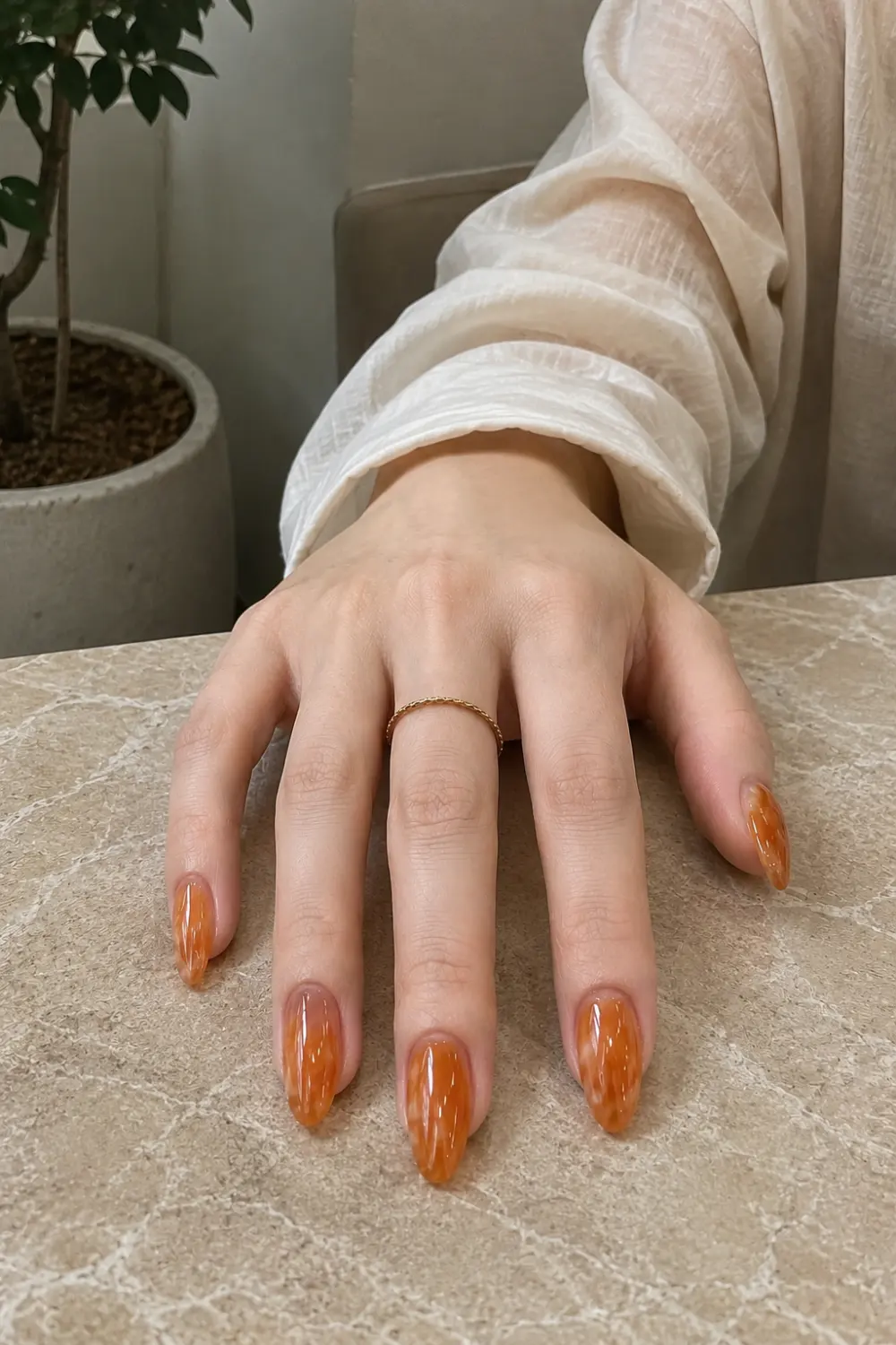 Amber jelly almond nails with warm honey-toned translucent gel polish, glossy finish, elegant almond shape, and rich caramel-inspired coloring for a luxurious manicure.
