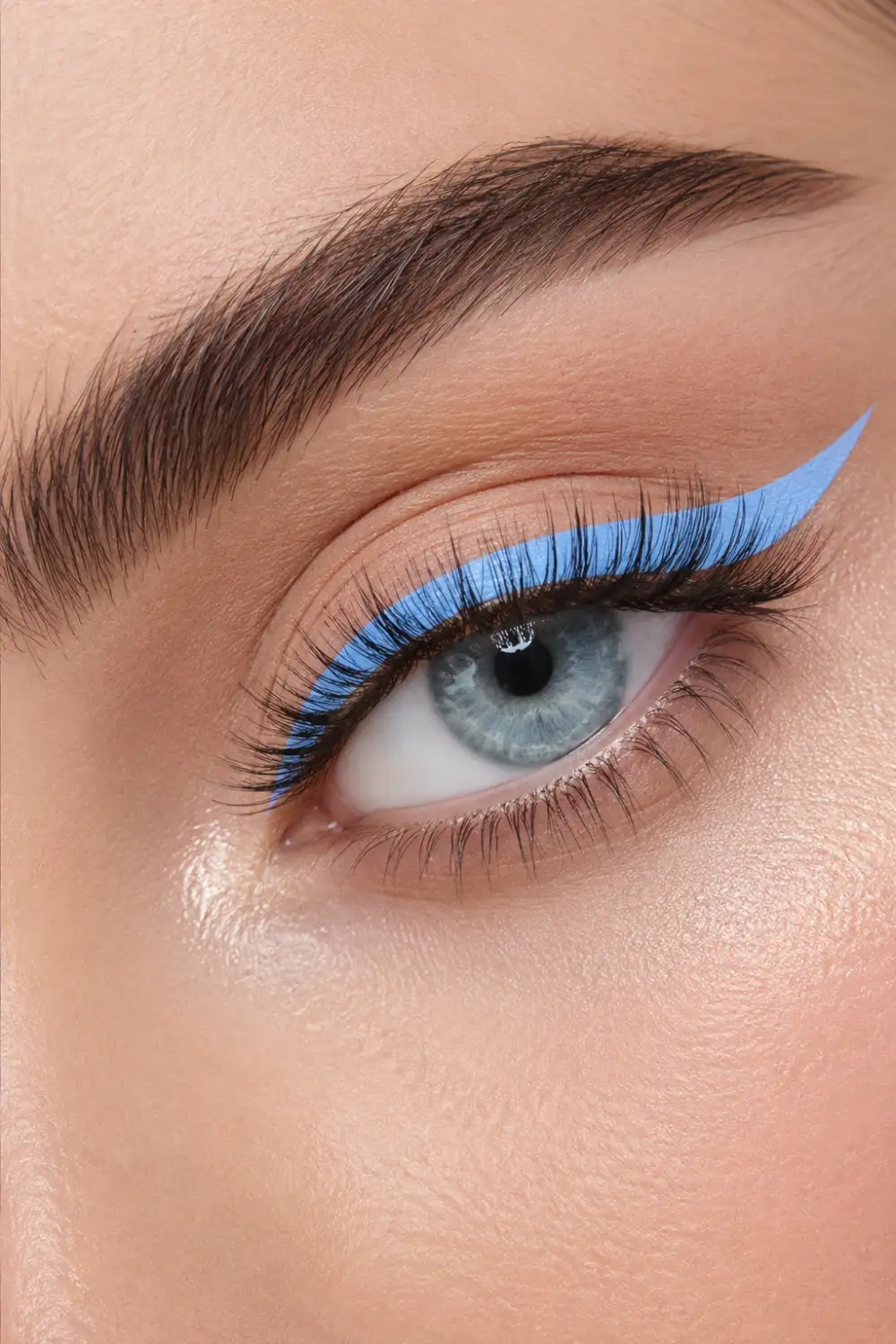 Soft pastel blue winged eyeliner makeup featuring minimal eyeshadow, glowing skin, defined lashes, natural brows, and a fresh summer beauty aesthetic inspired by modern makeup trends.