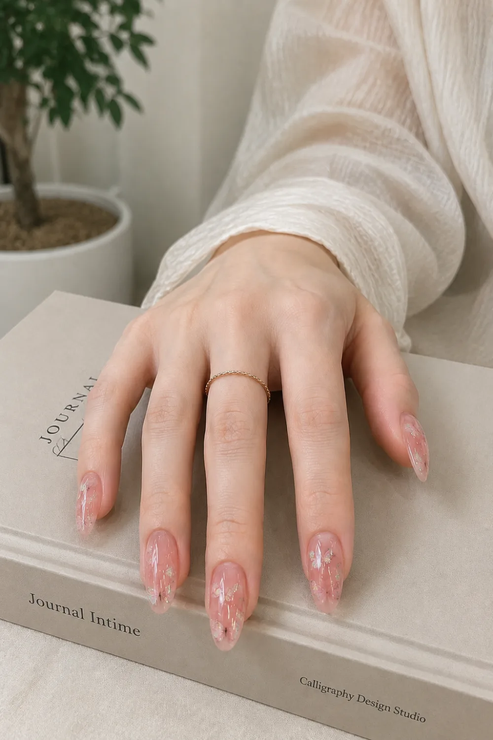 Clear jelly almond nails with iridescent foil accents, glossy translucent pink base, delicate shimmer details, and a luxury manicure inspired by modern Korean nail trends.