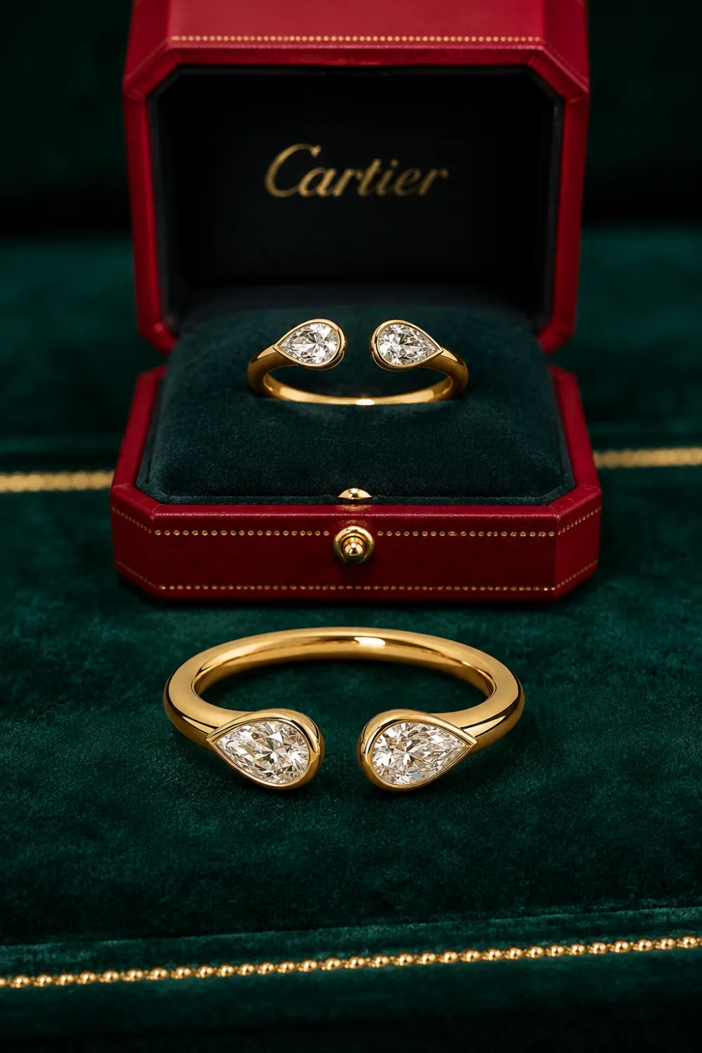 Open gap wedding ring featuring two pear-shaped diamonds, polished yellow gold band, modern open-ended ring design, luxury velvet jewelry box, contemporary wedding ring inspiration for stylish couples.
