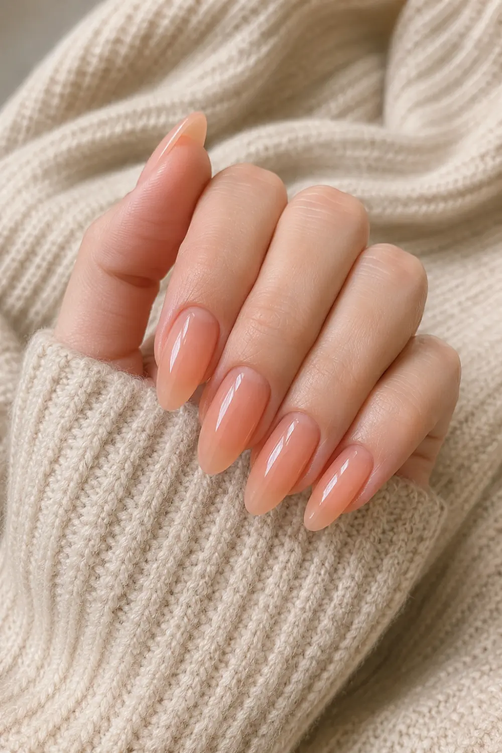 Korean lip gloss jelly almond nails with a peachy nude translucent finish, ultra-glossy shine, elegant almond shape, and a hydrated glass-like manicure effect.
